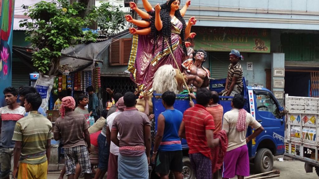 Porters loading a 2 meter high Durga statue onto a small truck in Kumartuli district of Kolkata