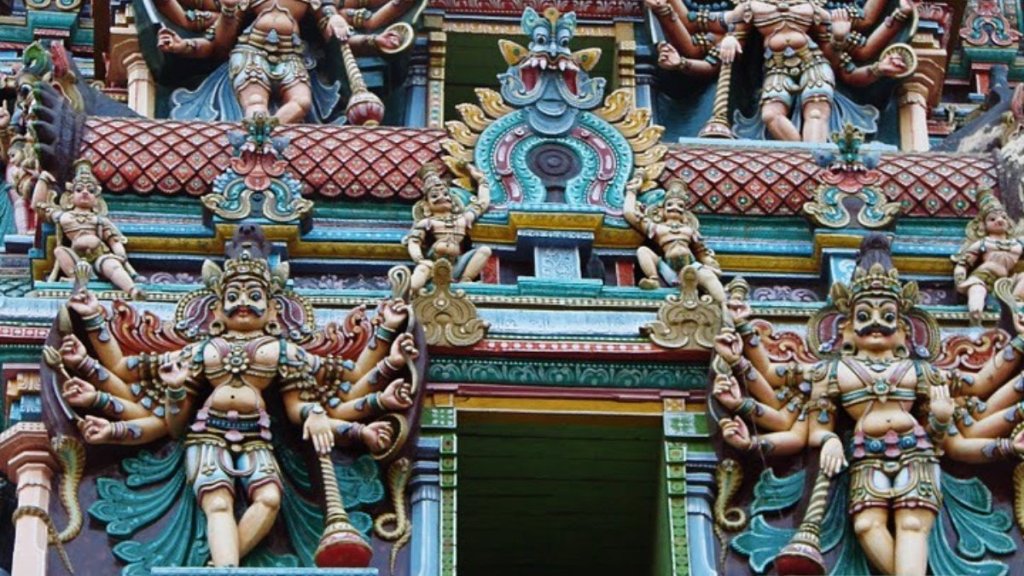 Colourful figures of gods adorn one of giant tower-gate in Minakshi temple