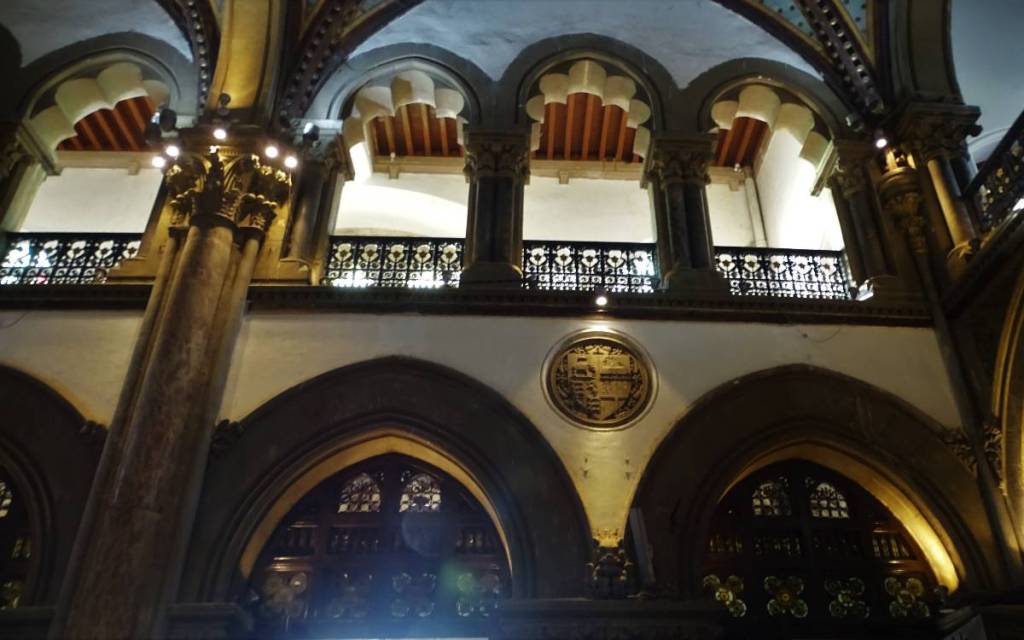 Oriental arched windows, gothic roof and neo-classical columns at the Mumbai railway station's ticket hall